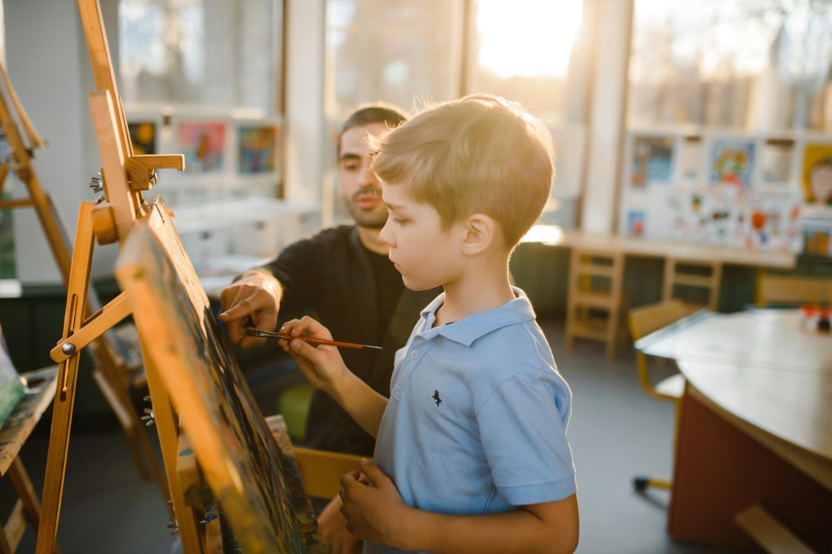 Creative arts workshop with people painting and crafting together in a bright studio