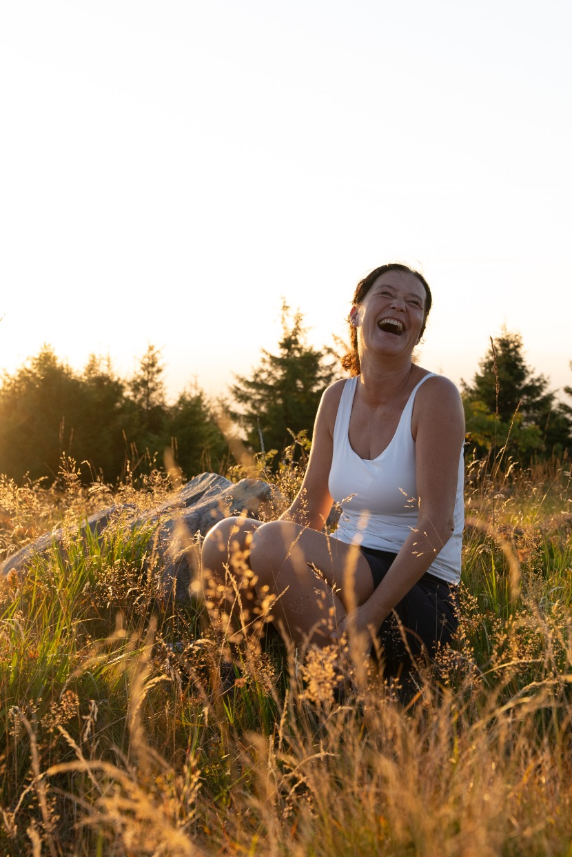 Kathleen of the 99active team laughing in the evening sun